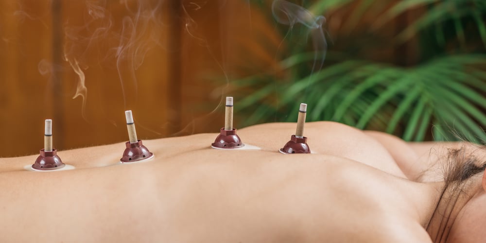 mugwort-moxibustion-back-therapy-burning-moxa-stick-placed-near-acupuncture-point